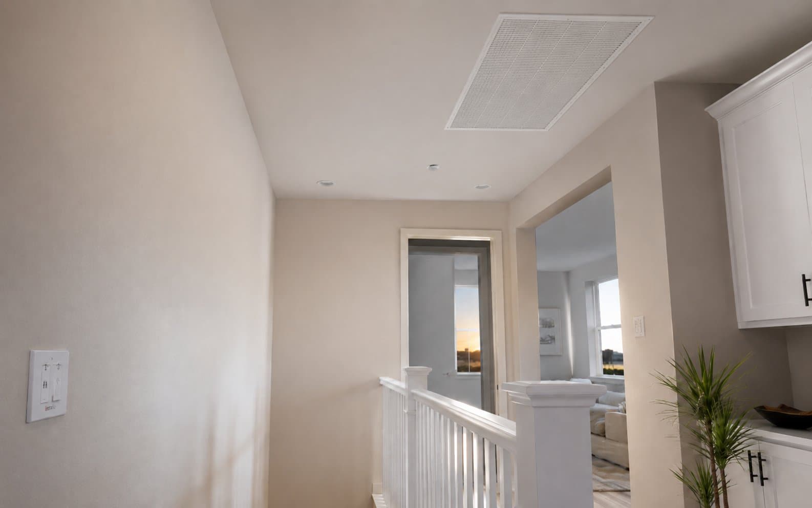 Whole house fan installed in the ceiling of an upstairs hallway with smart wall control